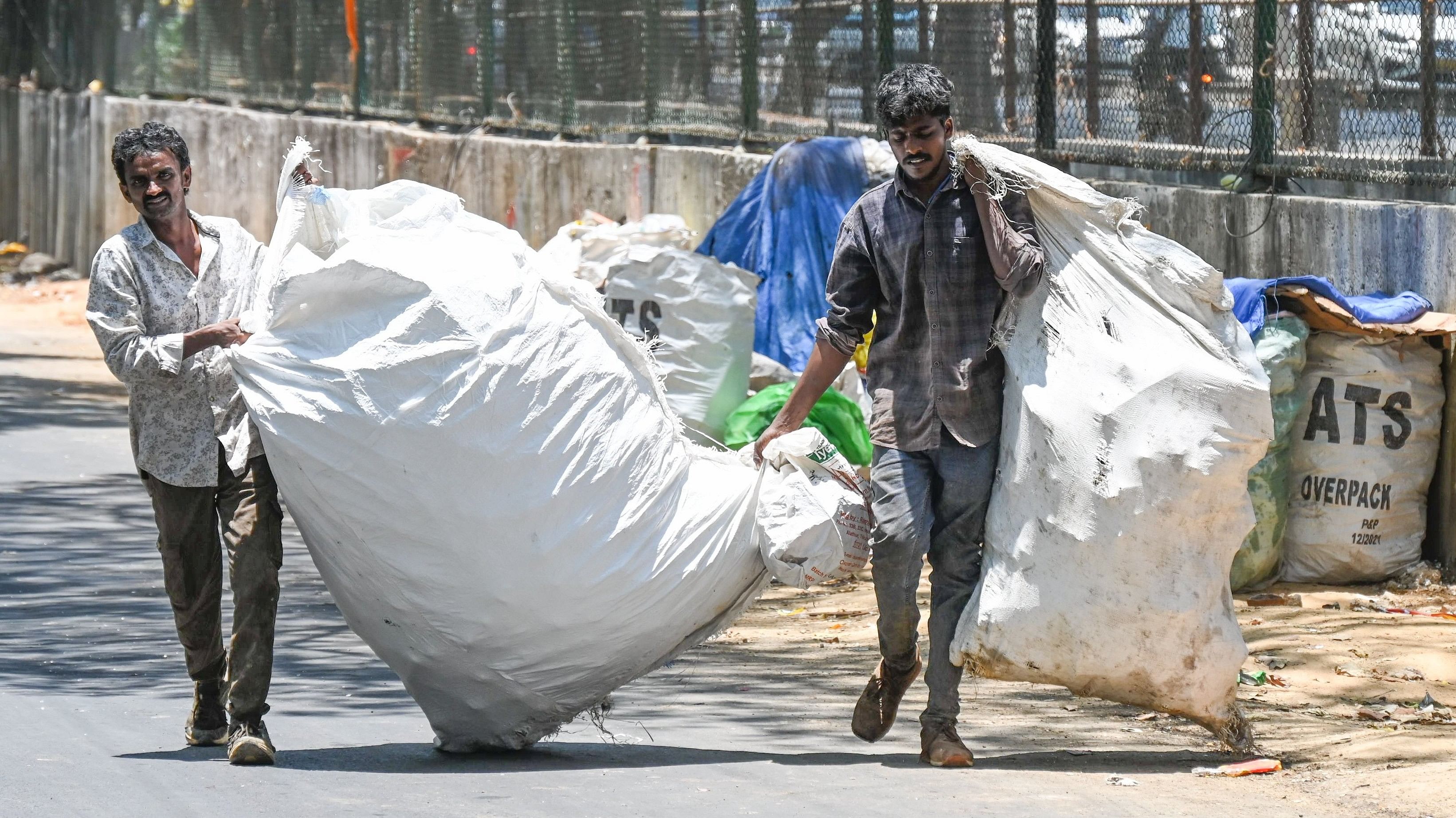 <div class="paragraphs"><p>Contract workers collect waste at Swamy Vivekananda Road. </p></div>