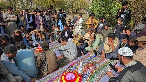 <div class="paragraphs"><p>People mourn over the graves of relatives who were killed after gunmen opened fire on passenger vehicles in the Kurram tribal district of Khyber Pakhtunkhwa province, in Shalozan, Pakistan November 22, 2024.</p></div>