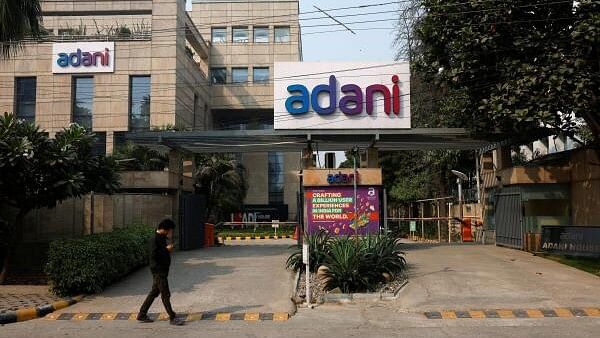 <div class="paragraphs"><p>A man walks past a corporate office of Adani Group in Gurugram, India, November 22, 2024.</p></div>