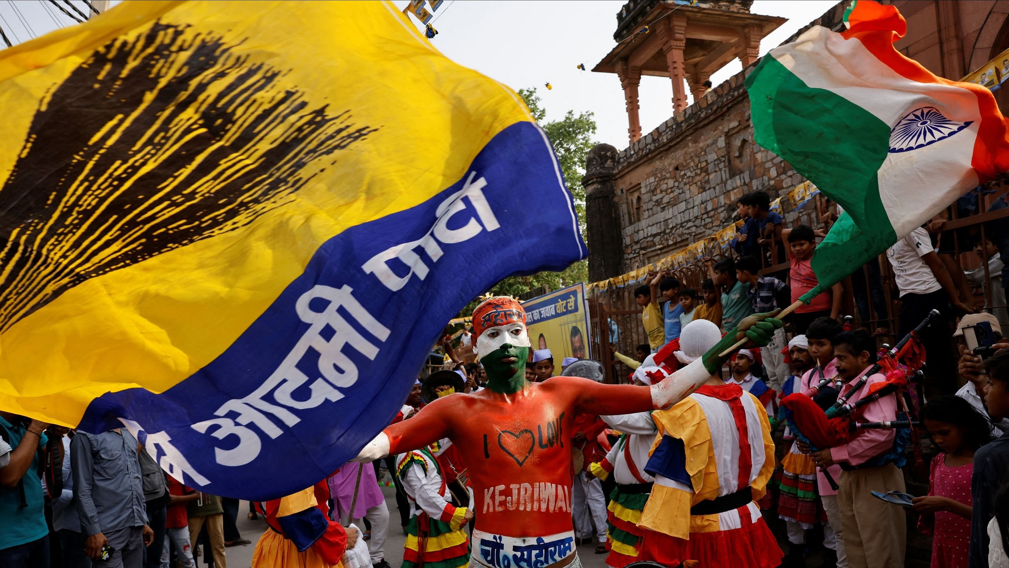 <div class="paragraphs"><p>A person with body paint waves the Indian tricolour and the flag of Aam Aadmi Party. </p></div>