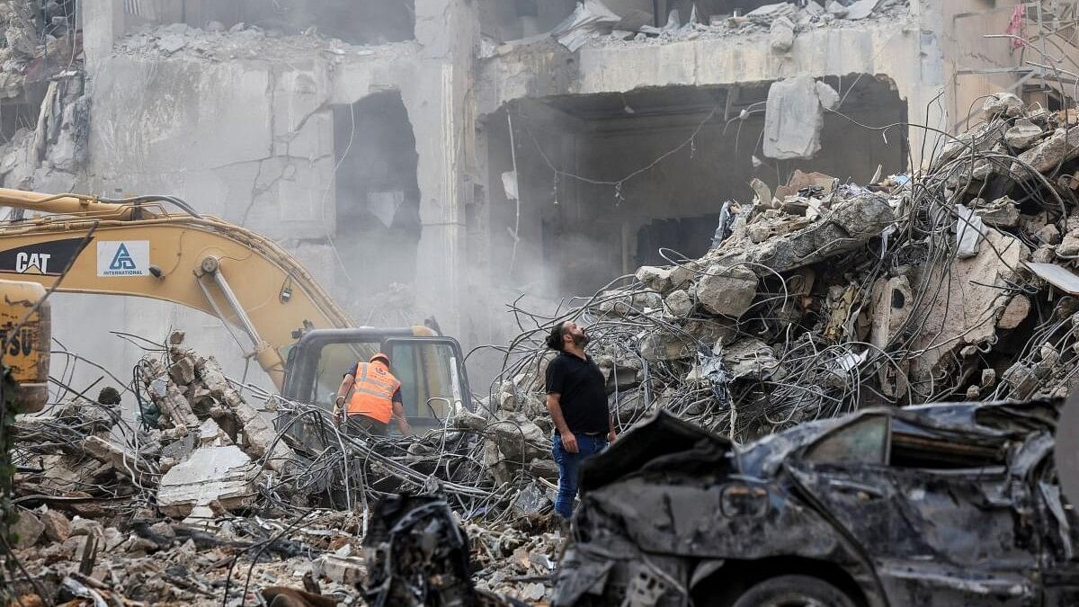 <div class="paragraphs"><p>Civil defense members and rescuers work at the site of an Israeli strike in Beirut's Basta.</p></div>