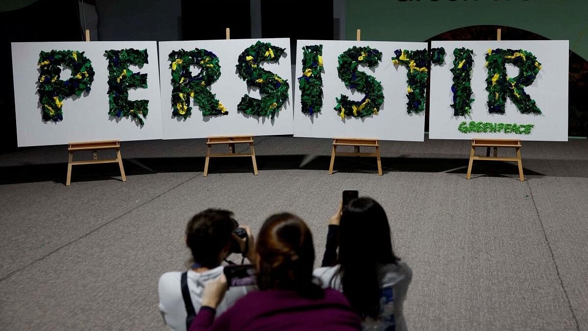 <div class="paragraphs"><p>Women take images of installation of placards by Greenpeace with the word “Persist” written on it as the message to the next year’s COP30 in Brazil during the COP29 United Nations climate change conference, in Baku, Azerbaijan November 22, 2024.</p></div>