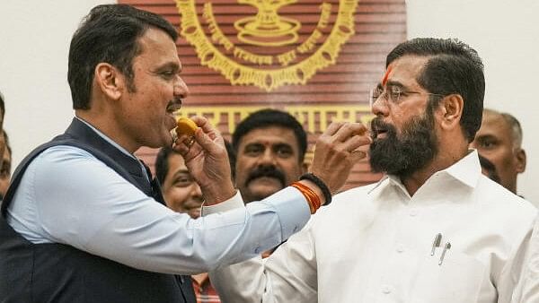 <div class="paragraphs"><p>Maharashtra Chief Minister Eknath Shinde and Deputy Chief Minister Devendra Fadnavis offer sweets to each other during a press conference as the BJP-led Mahayuti alliance secures victory amid the counting of votes for the Maharashtra Assembly elections, in Mumbai, Saturday, Nov. 23, 2024.</p></div>