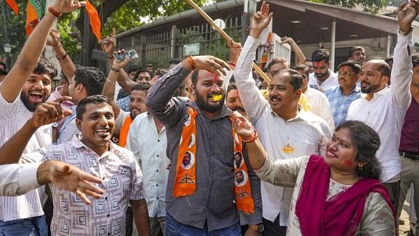 <div class="paragraphs"><p>Shiv Sena (Shinde faction) party workers celebrate as BJP-led Maha Yuti alliance leads amid the counting of votes for the Maharashtra Assembly elections, in Mumbai, Saturday, Nov. 23, 2024.</p></div>