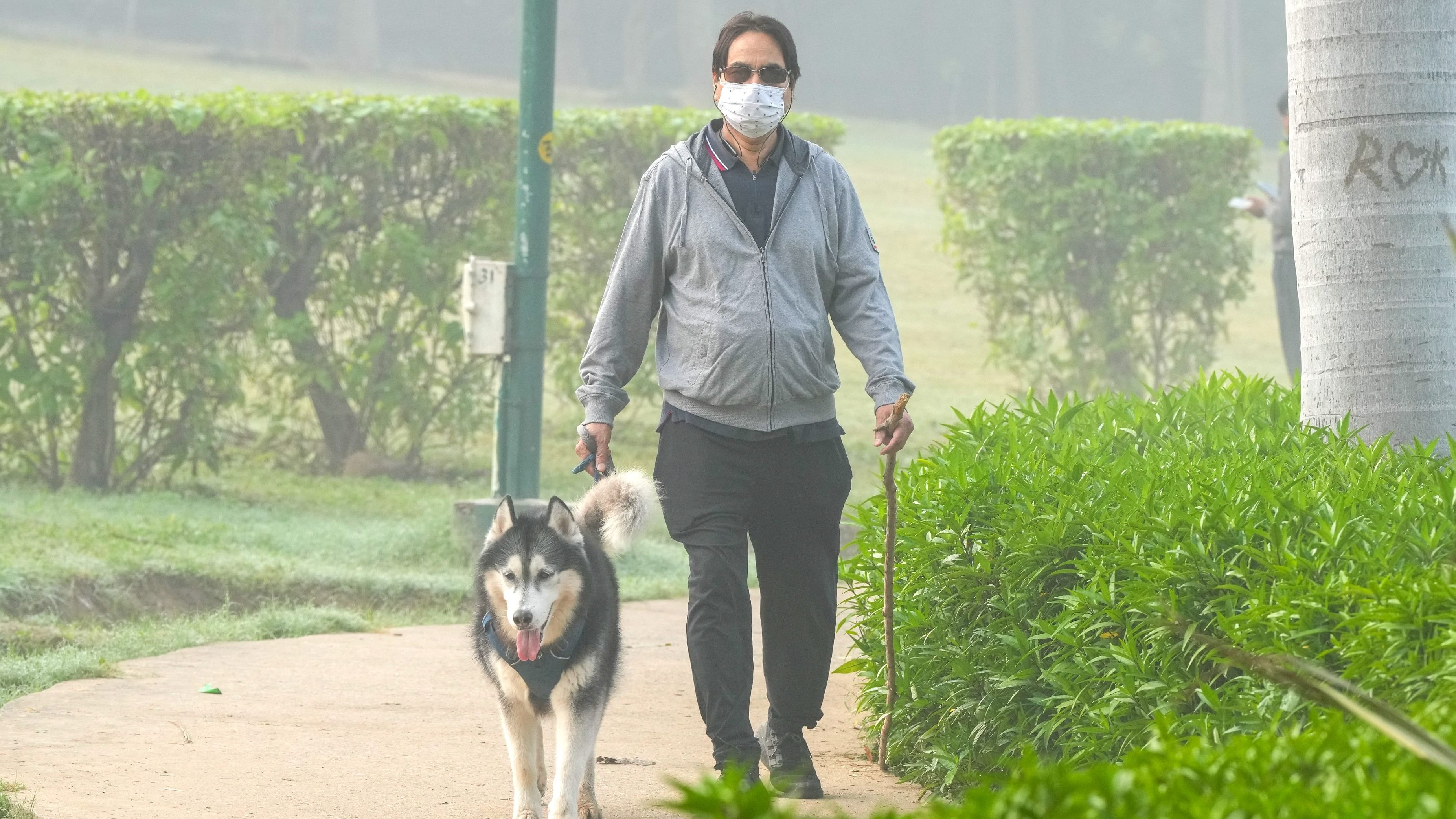 <div class="paragraphs"><p>A local, wearing face mask, with his pet dog at a park, in New Delhi.</p></div>