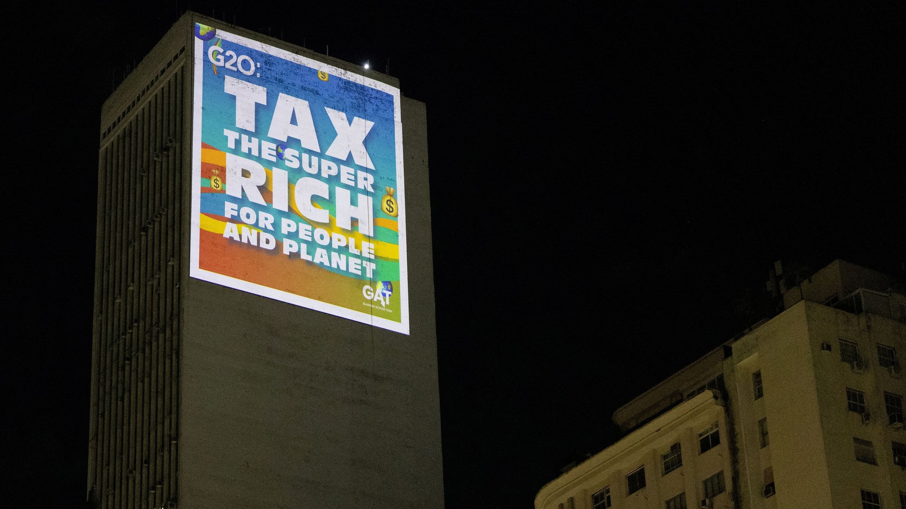 <div class="paragraphs"><p>Climate activists from the Glasgow Actions team project a message with an appeal for the taxation of the super-rich on a building during the G20 Summit in Rio de Janeiro, Brazil November 18, 2024. </p></div>