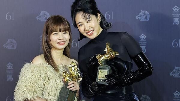 <div class="paragraphs"><p>Chen Hong-ren and Joanna Wang pose with the awards for Best Original Film Song for "Dead Talents Society" at the 61st Golden Horse Awards in Taipei, Taiwan.&nbsp;</p></div>