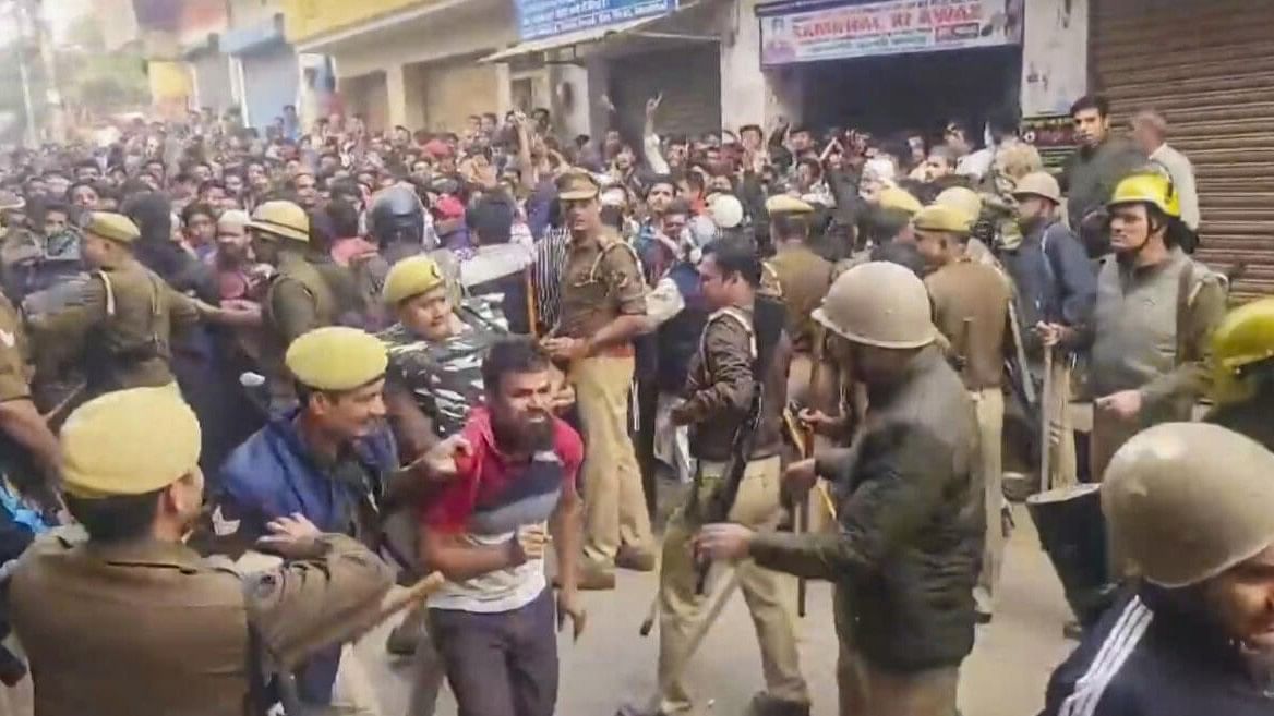 <div class="paragraphs"><p>Police and security personnel stand guard amid protest by locals during a second survey of the Jama Masjid, claimed to be originally the site of an ancient Hindu temple, in Sambhal</p></div>