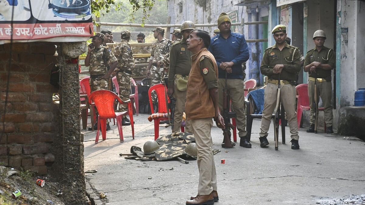 <div class="paragraphs"><p>Police personnel guard in a curfew bound street a day after violence eruted during the survey of the Jama mosque, in Sambhal</p></div>