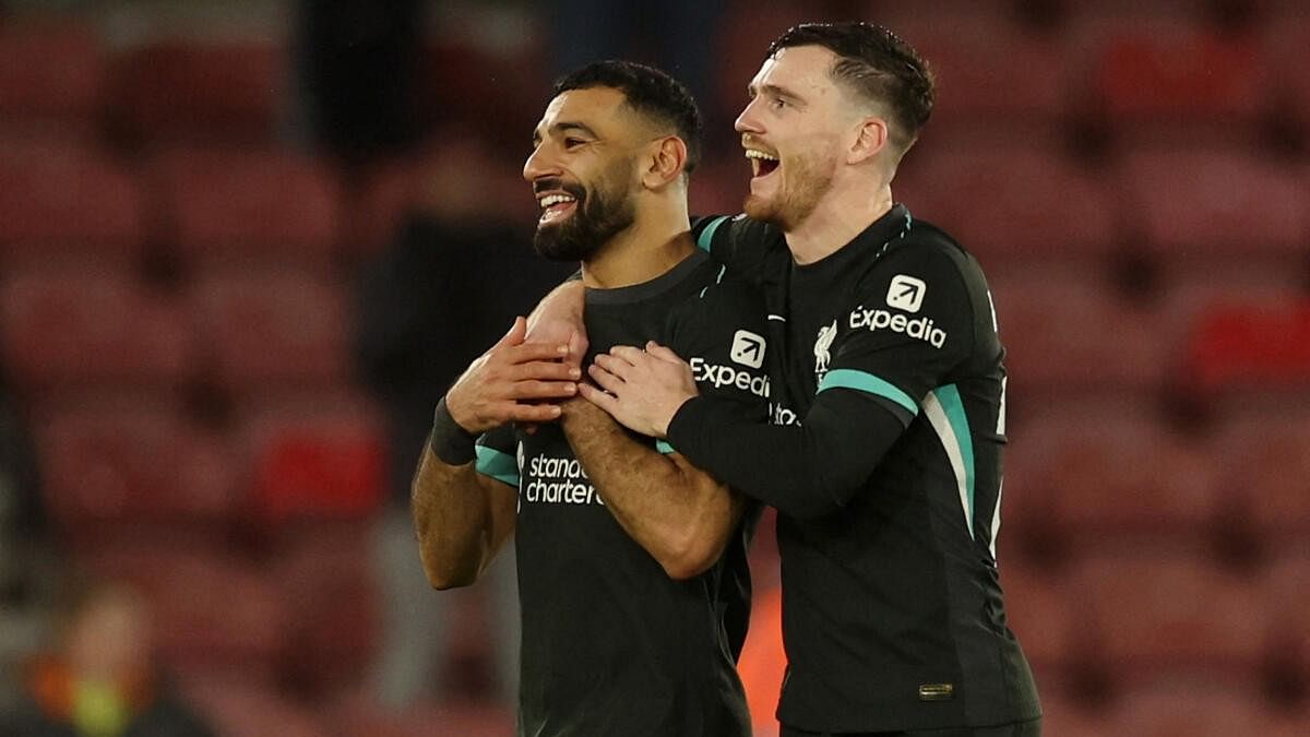 <div class="paragraphs"><p>Liverpool's Mohamed Salah, left, celebrates with team-mate Andrew Robertson after the win.</p></div>