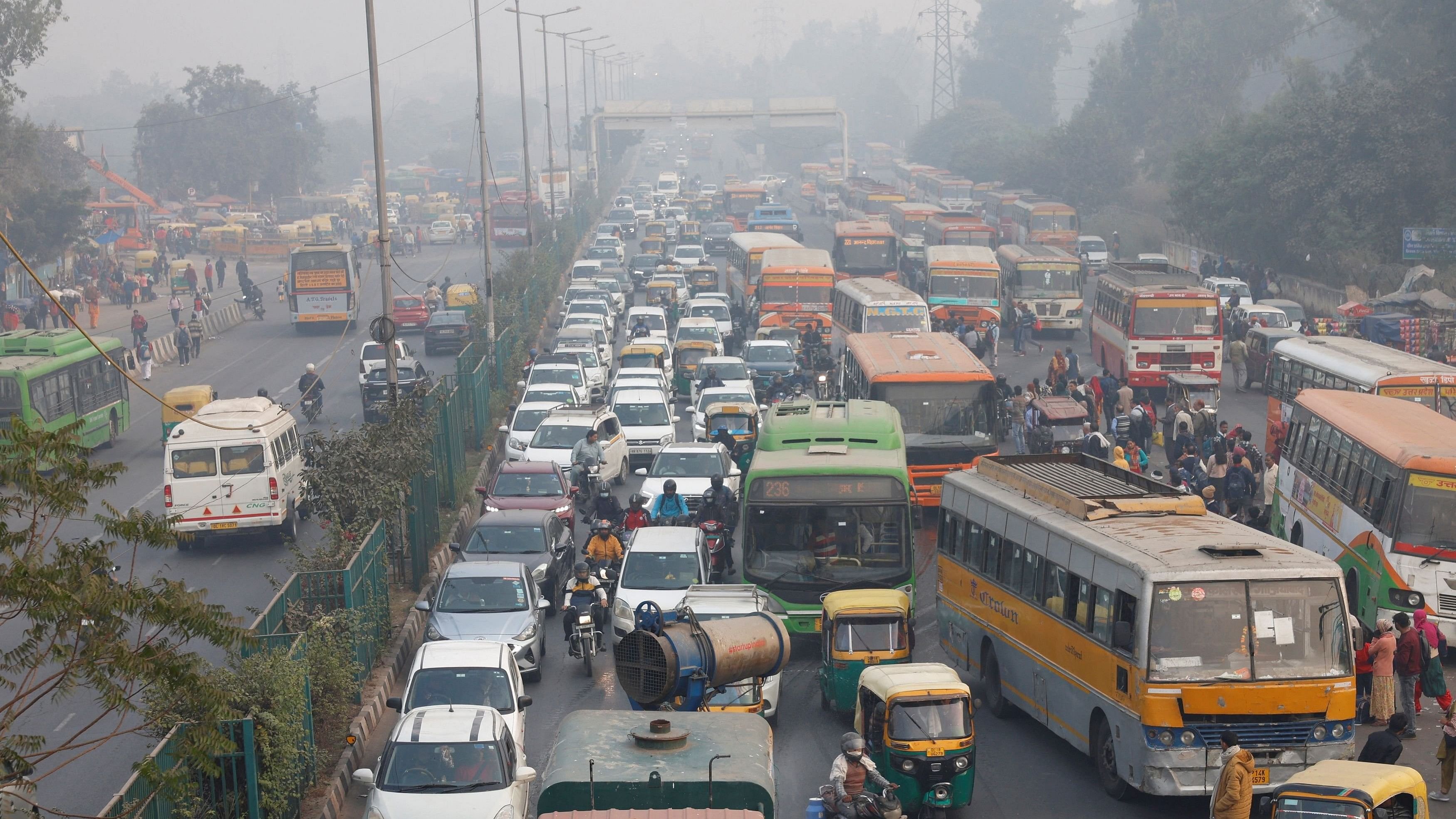 <div class="paragraphs"><p>An anti-smog gun sprays water to settle dust particles as traffic moves along a road, with the sky enveloped in smog due to air pollution in Delhi.</p></div>