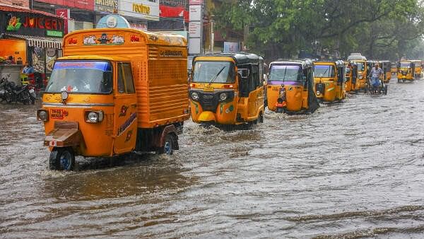 <div class="paragraphs"><p>Vehicles move through a flooded street amid rains, in Chennai, on Tuesday.</p></div>