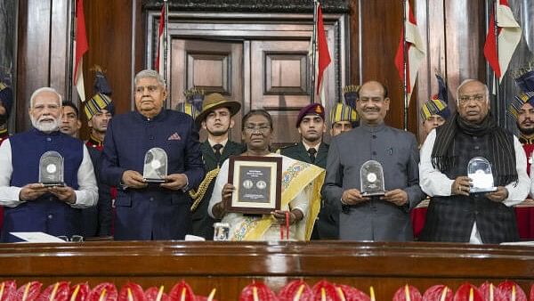 <div class="paragraphs"><p>President Droupadi Murmu with Vice President Jagdeep Dhankhar, Prime Minister Narendra Modi, Lok Sabha Speaker Om Birla and LoP in the Rajya Sabha Mallikarjun Kharge releases a commemorative coin during 'Samvidhan Divas' function at Samvidhan Sadan, in New Delhi.&nbsp;</p></div>