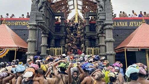 <div class="paragraphs"><p>Devotees wait to climb 18 steps to have 'darshan' of Lord Ayyappa after opening of the Sabarimala temple.</p></div>