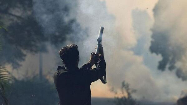 <div class="paragraphs"><p>A security force personnel fires a tear gas shell to prevent an anti-government rally by supporters of the former Pakistani Prime Minister Imran Khan's party, Pakistan Tehreek-e-Insaf (PTI), in Islamabad, Pakistan.&nbsp;</p></div>