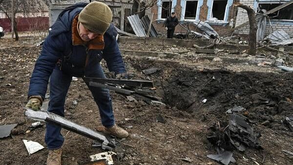 <div class="paragraphs"><p>A man inspects parts of a kamikaze drone at a site of a residential area damaged by a Russian drone strike in Ukraine's&nbsp;Zaporizhzhia.</p></div>