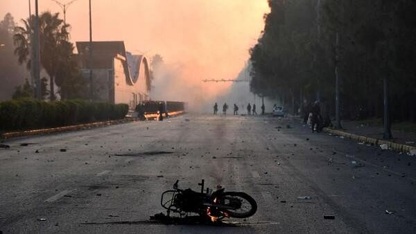 <div class="paragraphs"><p>A motorcycle burns during a protest rally by the supporters of the former Pakistani Prime Minister Imran Khan's party Pakistan Tehreek-e-Insaf (PTI) demanding the release of Khan, in Islamabad, Pakistan.&nbsp;</p></div>