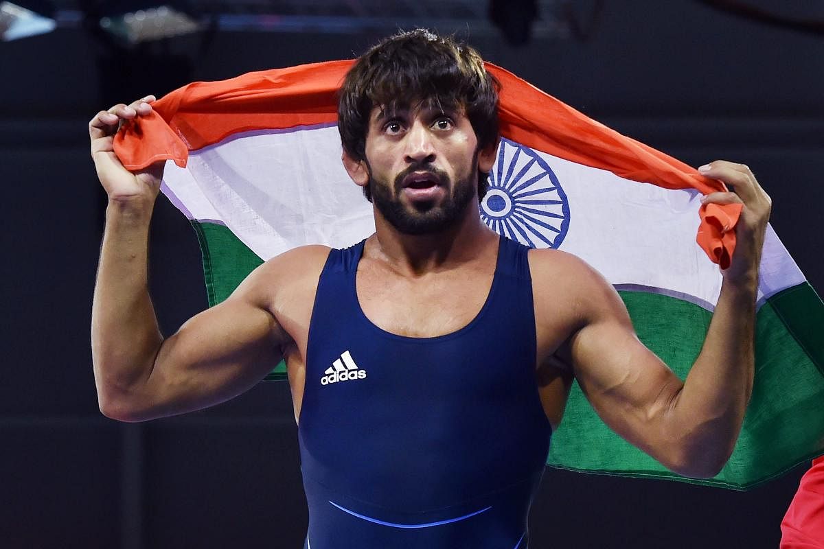 India's Bajrang celebrates after defeating Wales' Kane Charig to win gold in men's freestyle 65 kg wrestling event, at the Commonwealth Games 2018 in Gold Coast, on Friday. (PTI Photo)