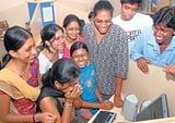 Students checking their PUC results on the net at a cyber cafe in Bangalore on Saturday. DH PHOTO/ M N  VASU