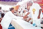 Mysore Lok Sabha constituency JDS candidate B A Jeevijaya and Congress candidate H Vishwanath shaking hands at a mass marriage programme in Madikeri o