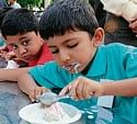 Children taking part in ice-cream eating competition in Mangalore on Sunday.