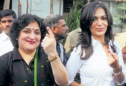 our right: Superstar Rajnikanths wife Latha Rajnikanth and their daughter Saundarya show the indelible ink mark on their fingers after casting votes