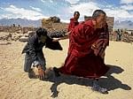 A monk, who voted, drags a polling agent outside a booth in Thiksey, 20 km from Leh, on Wednesday.