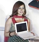 Actress Pooja Gandhi holds a Samsung N120 mini laptop during its launch in Bangalore on Thursday, PTI
