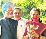 Moment to savour  Congress president Sonia Gandhi smiles after receiving a bouquet from Prime Minister Manmohan Singh. . AP