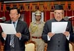 Pawan Chamling (L) being sworn in as the CM of Sikkim for the fourth time by the Governor Balmiki Prashad Singh  in Gangtok Wednesday. PTI