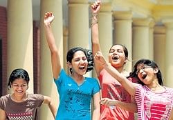 Students celebrate after the results for class 12 board exams were declared in New Delhi on Friday. AFP