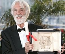 Austrian director Michael Haneke poses with the Palme d'Or award he received for the film 'The White Ribbon'. AP
