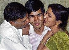 The All India Joint Entrance Examination topper Nitin Jain gets a peck from his parents, soon after the declaration of the results on Monday. PTI