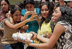 Students celebrate their success in the CBSE 10th standard examinations in Bangalore on Tuesday. DH Photo