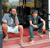 Smokers  killing time outside a coffee shop, before joining their friends inside.DH Photo/ Dinesh SK