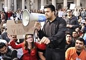 Thousands of protesting Indian students hold up placards at a rally in Melbourne on Sunday. AFP