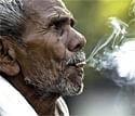 A man smokes 'bidi',  on "No Tobacco Day" in Allahabad on Sunday, AP