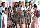 New year begins: Students waiting at the bus stop, on the day when schools reopened in Bangalore on Monday. DH PHOTO