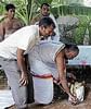 Priest performing pooja at the grave of the monkey.