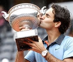 Roger Federer kisses the trophy after defeating Swedish player Robin Soderling during the French Open tennis men's final match on Sunday. AP
