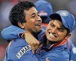 Pragyan Ojha (left) is congratulated by Suresh Raina during his man of the match-winning spell. Reuters