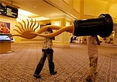 Workers carry a large replica of the International Indian Film Academy Awards statuette at a casino-hotel complex in Macau. AP