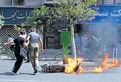 Supporters of reformist candidate Mir Hossein Mousavi fight running battles using stones and petrol bombs against police in Tehran on Saturday. AP