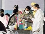 Doctors examine school students suspected to be infected with swine flu at a civil hospital in Jalandhar on Monday. AP