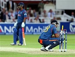 India's Yusuf Pathan (R) and captain MS Dhoni appear to be a picture of dejection at Lord's cricket ground, after bowing out of the T20 World Cup.