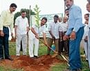 District In-Charge Minister J Krishna Palemar planting a sapling at Bondel in Mangalore on Thursday, as part of the Vruksharopana campaign. DH Photo