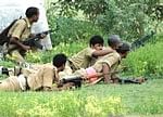 Policementake position during a gun battle with Maoists on the second day of the operation at Lalgarh inWest Midnapore district on Friday. PTI