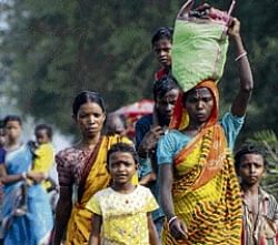 Villagers flee their homes after security forces launch an operation to reclaim a large area captured by Maoists at Bhattpur on Sunday. AP