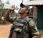 A CRPF jawan quenches his thirst while on vigil during the 48 hours-long bandh called by the Maoists, in Lalgarh on Monday. PTI