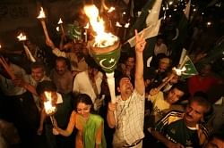 Pakistani cricket fans celebrate their country's team victory in the final of Twenty20 World Cup against Sri Lanka on Monday, AP